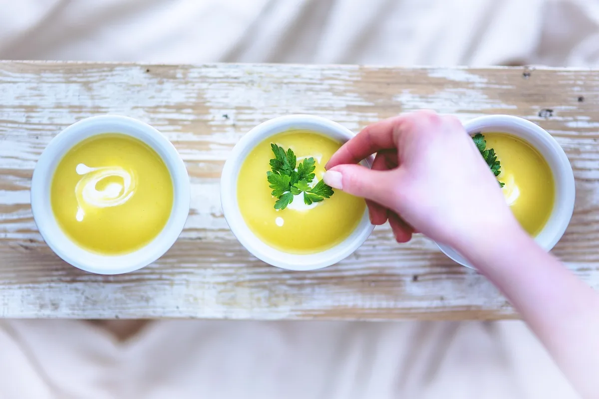 Préparation d'une soupe de légumes dans une casserole avec bouillon et légumes frais