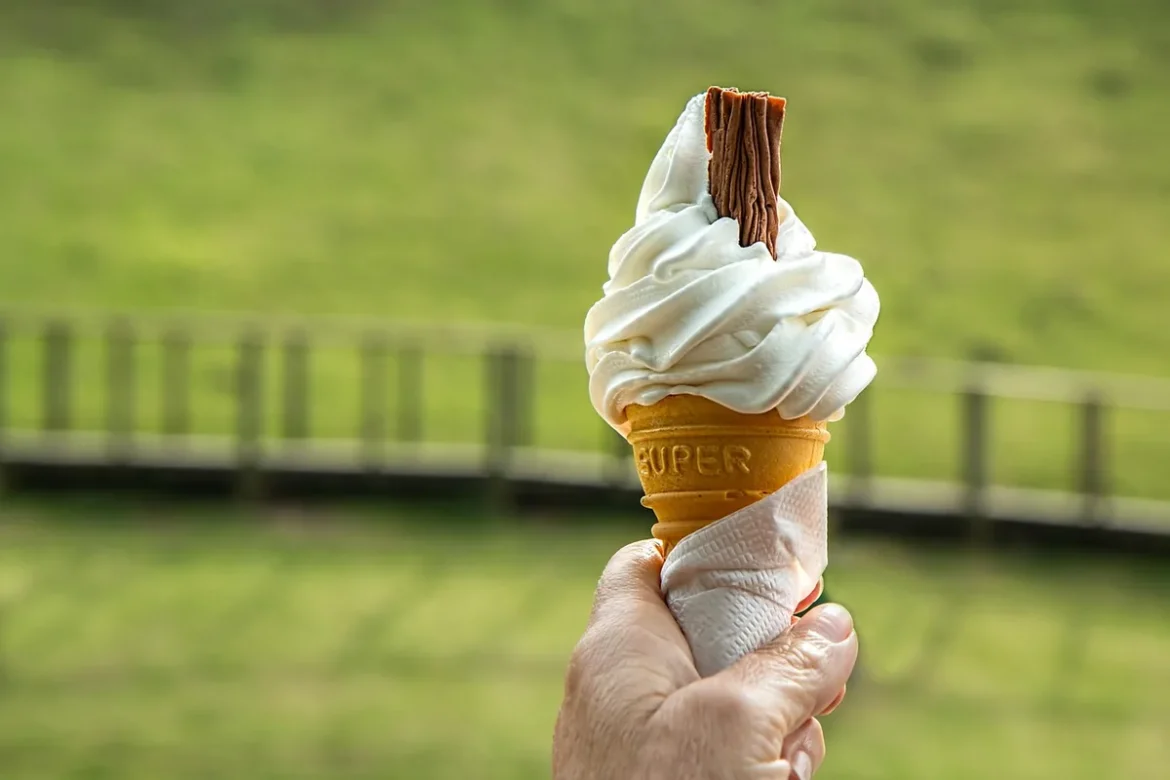 Main course of an ice cream cone with a scoop melting in the sun on a warm day